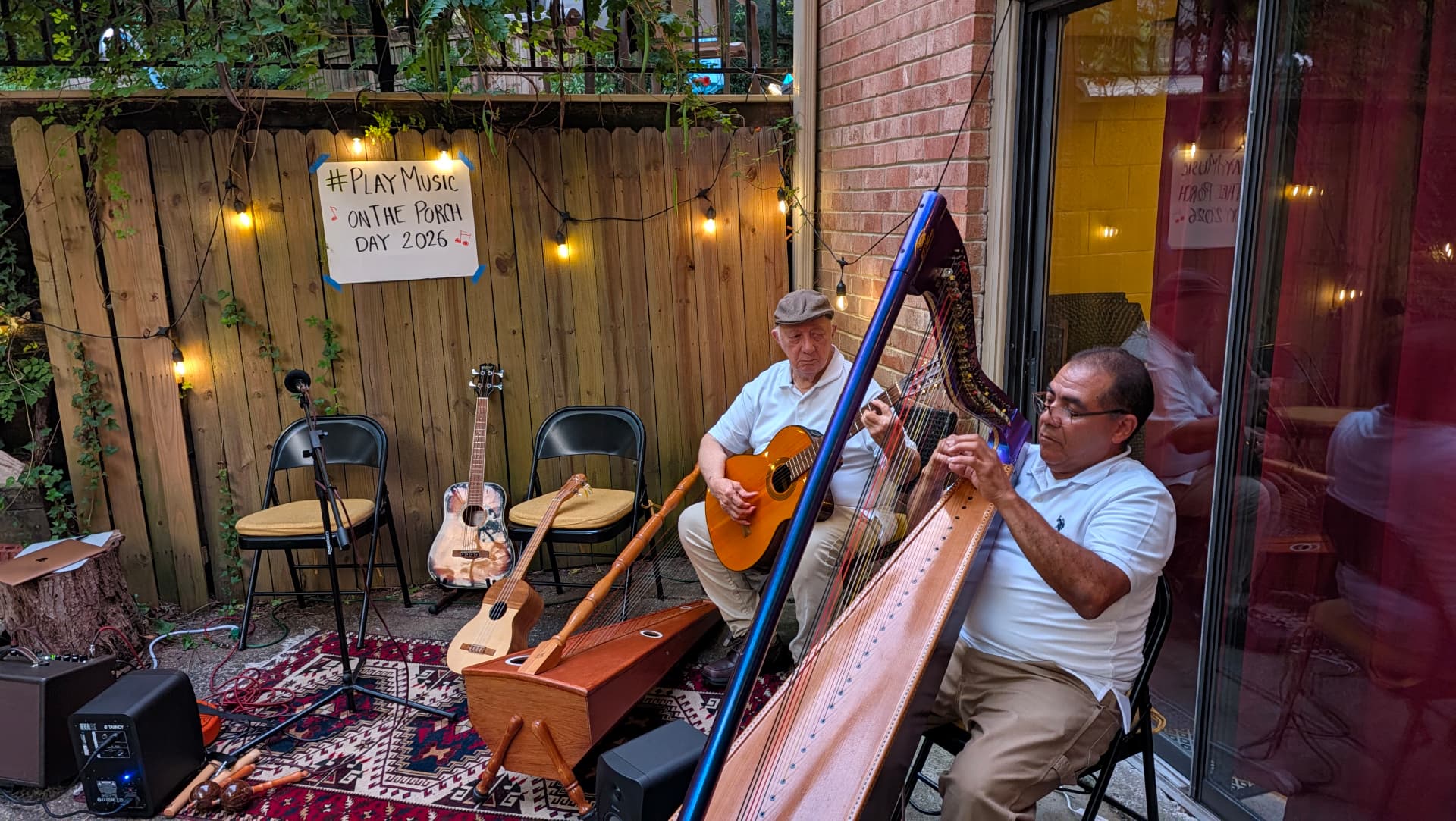 Two musicians performing on a porch